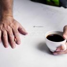 man-with-coffee-cup-over-renovation-plans.jpg