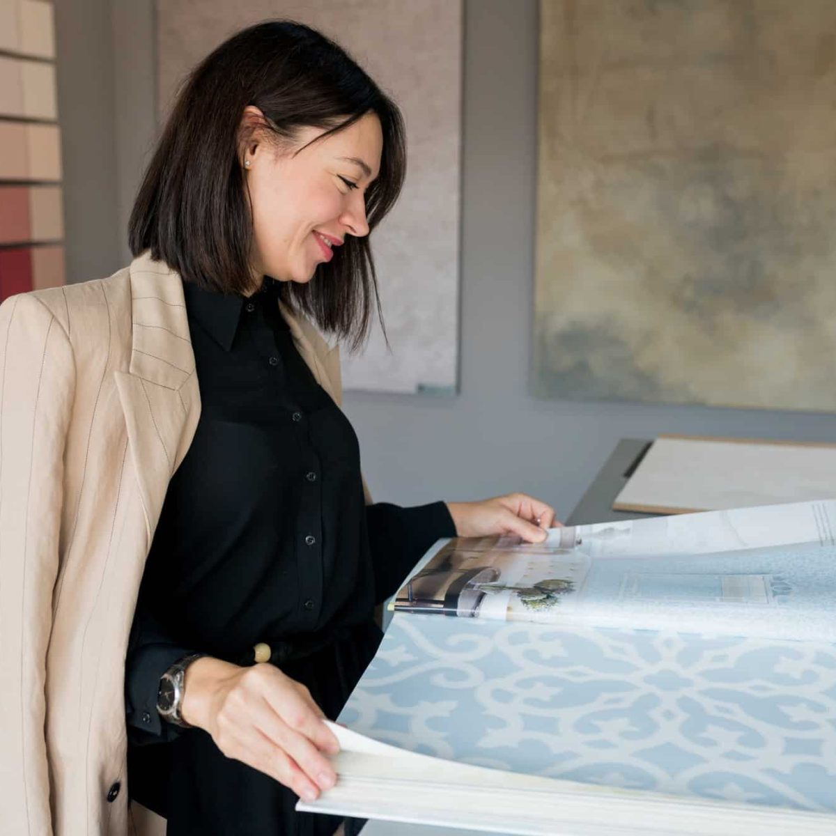 woman-designer-choosing-wallpaper-from-catalog-for-home-renovation.jpg